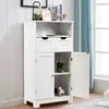 A white wooden cabinet with two drawers and two doors, one of which is open, displaying shelves and decorative items. Náhled obrázku produktu