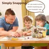 A father and two children are assembling a miniature dollhouse kitchen. Podgląd zdjęcia produktu