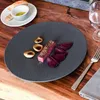 A plate of food with steak, beets, and bread with olive oil on a wooden table. Voir les images du produit