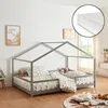 A child's bed with a house frame, set up in a room with toys and decorations. Náhled obrázku produktu