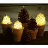 A collection of pinecone-shaped LED lights in terracotta pots, arranged on a wooden surface. Produktbild-Vorschau