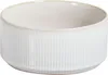 A close-up studio shot of a white ceramic bowl with vertical ribbed texture. Náhľad obrázku produktu