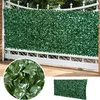 A green artificial ivy hedge is attached to a white gate. Náhled obrázku produktu