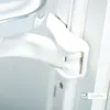 A close-up view of a white cabinet fitting mechanism, likely for a corner unit. Produktbild-Vorschau