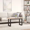 A living room scene with a couch, coffee table, and bookshelf. Voir les images du produit