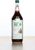 A bottle of Spitz Jagertee concentrate on a wooden surface against a white background. Produktbild-Vorschau