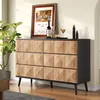 A sideboard with a framed picture, wine bottle, and cocktail on top, placed in a room. Produktbild-Vorschau