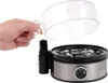 A hand holding the lid of an egg cooker. Produktbild-Vorschau