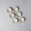 A top-down view of six beige ceramic bowls arranged on a light gray background. Produktbild-Vorschau