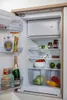 An open refrigerator filled with various food and drink items. Produktbild-Vorschau