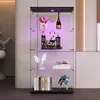 A glass display cabinet with items on shelves, illuminated by purple LED lights. Podgląd zdjęcia produktu