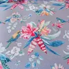 A close-up view of a fabric with a floral and bird pattern. Produktbild-Vorschau