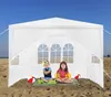 Two children sitting inside a white tent on a sandy beach. Voir les images du produit