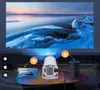 A projector is shown projecting an image onto a screen, with icons indicating connectivity to Android, Apple, Windows devices, Wi-Fi, and Bluetooth speakers. Produktbild-Vorschau
