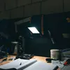 A workbench with tools and a bright LED work light illuminating the area. Produktbild-Vorschau