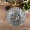 A top-down view of a decorative ceramic sink with a brass faucet, placed on a wooden surface. Anteprima dell’immagine prodotto