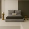 A minimalist bedroom scene featuring a bed, nightstand, and stool. Produktbild-Vorschau