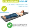 A woman is lying on a folded mattress. Produktbild-Vorschau