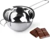 A stainless steel double boiler insert with a handle and two pouring spouts, next to two squares of chocolate on a white background. Voir les images du produit