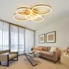 A modern living room with a sofa, coffee table, armchair, and a ceiling light. Náhled obrázku produktu