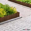 A wooden garden border with plants next to a cobblestone path. Produktbild-Vorschau