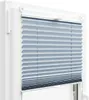 A close-up view of a light blue pleated blind installed in a white window frame. Podgląd zdjęcia produktu