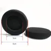 Two black foam ear pads for headphones are shown on a white background. Dimensions are indicated with red lines and blue arrows. Produktbild-Vorschau