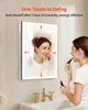 A woman applying lipstick in front of a lighted mirror in a bathroom. Produktbild-Vorschau