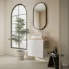 A modern bathroom with a vanity, sink, mirror, and a large arched window. Produktbild-Vorschau