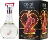 A perfume bottle and its packaging are displayed side-by-side against a black background. The packaging features a heart-shaped design with lights and a woman in a red dress. Náhľad obrázku produktu