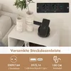 A close-up view of a power strip with multiple outlets and USB ports, along with a wireless phone charger and a smartphone, placed on a bedside table. Náhľad obrázku produktu