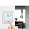 A hand is shown interacting with a digital thermostat mounted on a white wall, with a blurred background of a room interior. Náhľad obrázku produktu