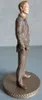 A side view of a figurine of a man in a suit, standing on a circular base. Produktbild-Vorschau
