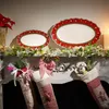 Christmas-themed fireplace mantel decorated with festive platters, garlands, and stockings. Anteprima dell’immagine prodotto