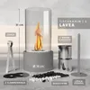 A table fireplace with its accessories laid out around it. Produktbild-Vorschau