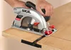 A person is using a Skil circular saw to cut a piece of wood. Náhľad obrázku produktu