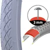 A close-up of a bicycle tire with an inset graphic illustrating its puncture resistance. Podgląd zdjęcia produktu