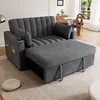 A gray sofa bed with an extended ottoman is shown in a living room setting, with a round cushion on the floor in the foreground and a dining set visible in the background. Podgląd zdjęcia produktu