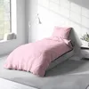 A bedroom setting with a bed dressed in pink bedding. Produktbild-Vorschau
