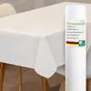 A white tablecloth is draped over a table, with a roll of tablecloth material standing next to it. Produktbild-Vorschau