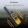 A walkie-talkie is shown in a natural outdoor setting with people in the background. Podgląd zdjęcia produktu