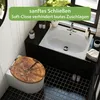 A modern bathroom with a toilet and sink, featuring a wooden toilet seat. Podgląd zdjęcia produktu