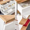 Collage of images showing details of a white bathroom cabinet with wooden accents. Produktbild-Vorschau