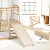 A wooden indoor climbing frame with various features like a slide, net, and ladder, shown with close-up insets highlighting specific components. Produktbild-Vorschau