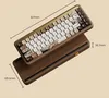 A mechanical keyboard with a wooden base and decorative keycaps, shown with dimensions. Produktbild-Vorschau