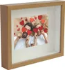 A framed photo of a couple holding red hearts over their eyes. Náhľad obrázku produktu