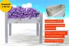 A raised garden bed filled with purple flowers, set against a sky background. Text overlays highlight product features. Produktbild-Vorschau