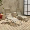 Two beige foldable sun loungers are placed on a wooden deck next to a concrete wall and a large window. Anteprima dell’immagine prodotto