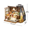 A miniature dollhouse kitchen scene with various accessories and furniture. Náhľad obrázku produktu