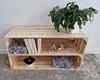 A wooden crate shelf unit with decorative items and a plant. Náhled obrázku produktu